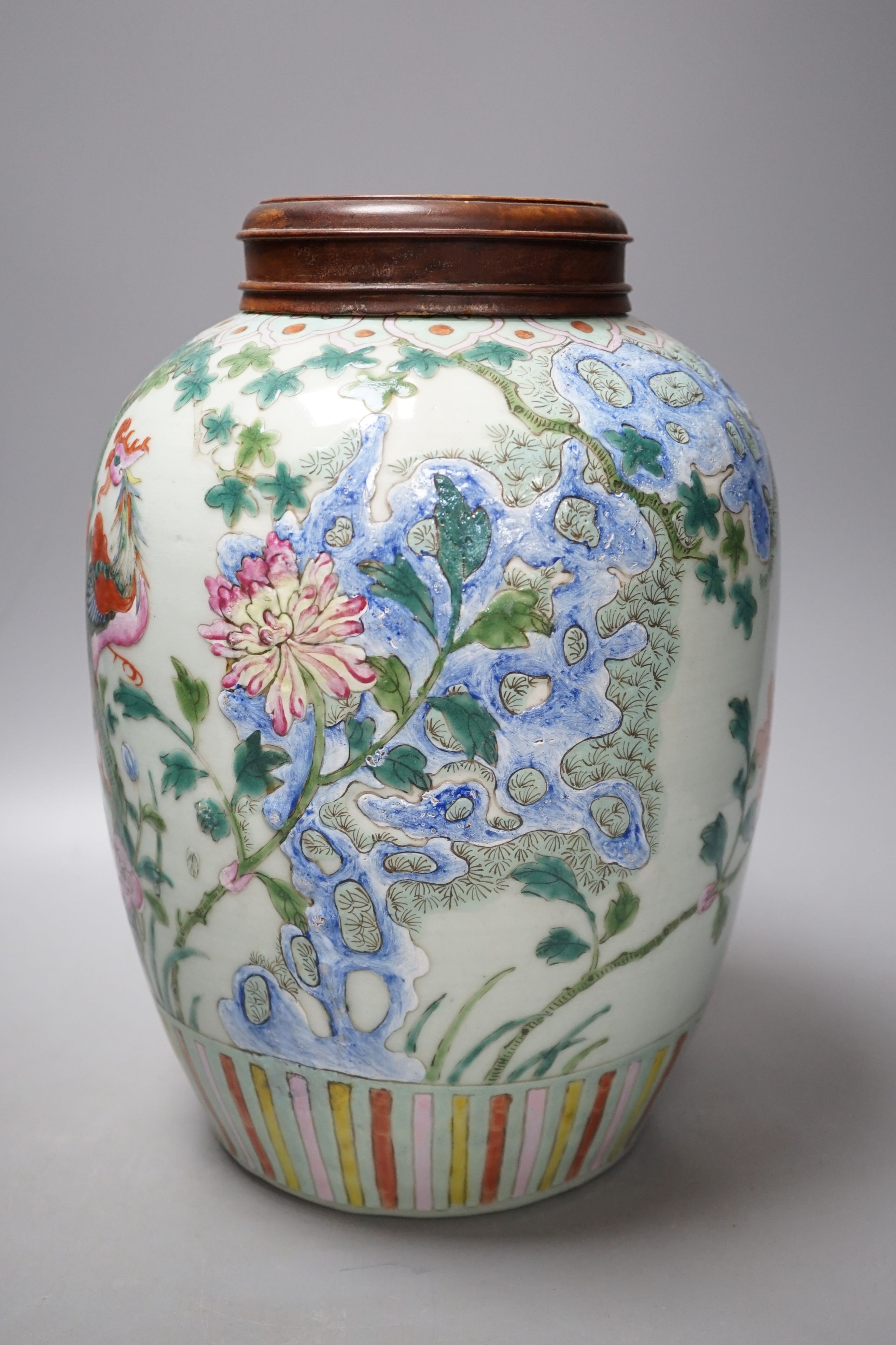 A Chinese Straits famille rose ‘phoenix’ jar and Hongmu cover, 30 cms high including cover.